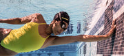 A swimmer wearing FORM smart swim goggles touches the wall