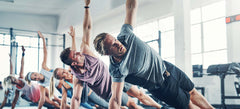 group of athletes doing yoga