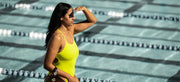 A lady looking ahead with FORM goggles on her wrist